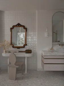 Modern bathroom with terrazzo floor, white walls, and minimalist design.