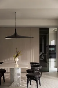 A modern dining room featuring a marble table and chairs.