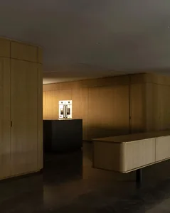 A modern kitchen with wooden cabinets and a black island.