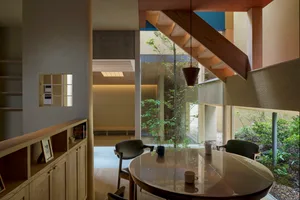 A modern dining room featuring wood furniture and minimalist design.