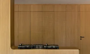 A modern home studio with wooden walls and a sleek, contemporary design.