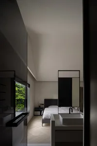 Modern minimalist bathroom with glass and wooden elements.