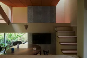 A modern minimalist living room featuring wooden furniture and a cozy ambiance.