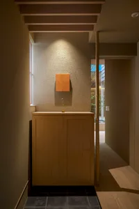 Modern industrial entryway with wooden cabinet and minimalist design.