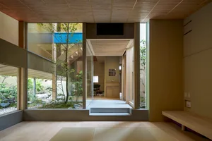 A modern residential interior featuring wood, concrete, and glass materials.