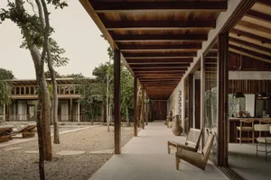 Modern residential patio with wood accents and a covered walkway.
