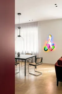 A modern dining room featuring a table, chairs, and a colorful neon sign of a person riding a scooter.