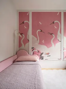 A minimalist bedroom featuring a pink bed with a fabric headboard and a wall mural of pink cranes and dragonflies.