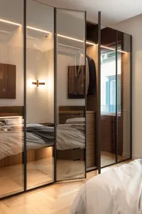 Modern minimalist closet with glass doors and LED lighting