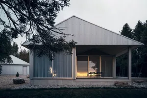 Modern minimalist residential house with metal siding and large glass windows