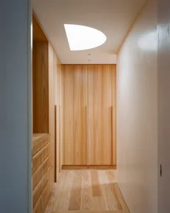 Modern closet with wooden shelves and ceiling light cutout