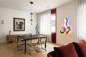 A modern dining room featuring sleek black furniture, glass windows, and colorful scooter neon light.