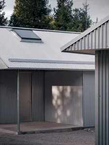 Modern residential entryway featuring metal-clad exterior and skylight.
