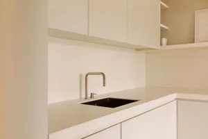 A modern kitchen featuring a sleek stone countertop and minimalist design.