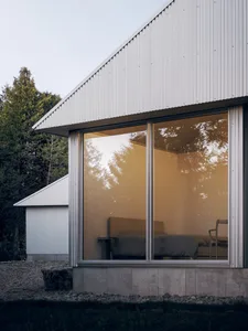 Modern residential architecture featuring glass and metal materials.