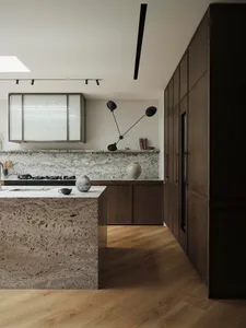 A modern kitchen featuring granite countertops and minimalist design elements.