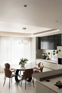 Modern kitchen with marble table, leather chairs, and floating glass cabinets.