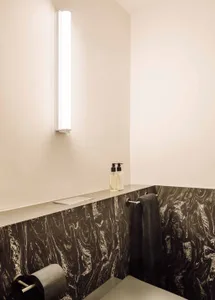 Modern minimalist bathroom featuring a slide with marble and concrete materials.