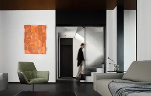 Modern lounge with stylish cube art, minimalistic furniture, and sleek design.