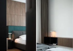 Bedroom with modern minimalist design featuring wood paneling, leather headboard, and fabric bedding.