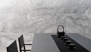 Modern, minimalist tea ceremony setting with concrete walls and a black table.