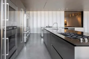 Modern residential kitchen with metallic surfaces and sleek design.