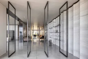 A modern minimalist living space with concrete walls and open layout.