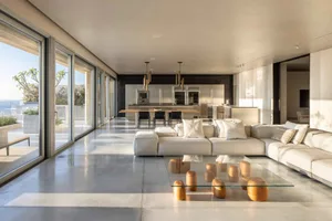 Modern minimalist living room with concrete floor and large windows.