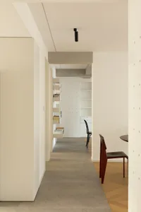 Modern residential interior featuring minimalist design, concrete flooring, wooden accents, and metal elements.