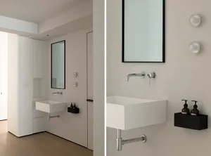 A minimalist bathroom features a white concrete sink with glass accents, situated within a minimalist interior design setting