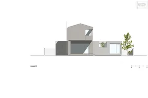 Modern house with a concrete exterior and large windows.