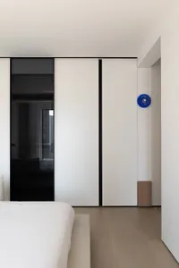 Modern residential interior with white laminate flooring and minimalist design.