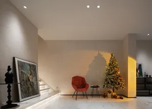 Christmas tree adorned with lights, ornaments, and gifts in a cozy interior setting.