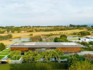 An aerial view of a modern architectural design with a focus on the mixed materials used in the construction.