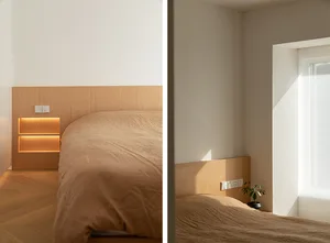 Modern, minimalist bedroom featuring wooden headboard and beige bedding.
