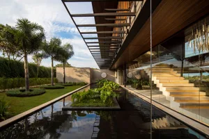 Modern residential house exterior with concrete and glass materials.