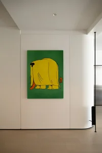 A modern painting featuring a yellow elephant on a green background, viewed from the rear.