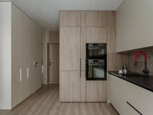 Modern minimalist kitchen featuring wood cabinets and a sleek, integrated design.