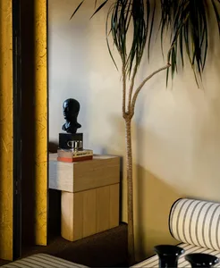 Minimalist living room featuring modern wood accents and a black sculpture on a wooden side table.