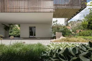 Modern architectural design featuring wooden exterior materials and a large balcony.