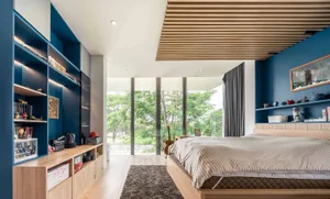 A modern bedroom featuring wood, blue, and grey colors.