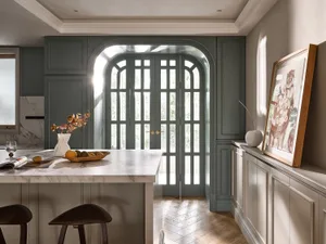 Modern kitchen features marble white cabinets and wooden flooring
