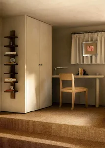 Minimalist home office with a neutral color scheme, featuring a desk, chair, and bookshelf.