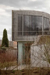 A modern building with a wooden facade, characterized by clean lines and a minimalist design.