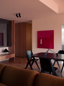 A modern residential interior featuring a combination of wooden, metallic, and fabric elements.