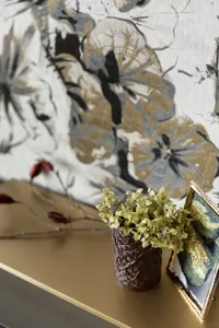 A metallic surface with a decorative plant arrangement on a shelf.