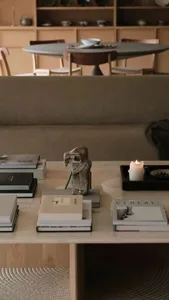 A modern interior design featuring a comfortable sofa and a stylish table with decorative items.