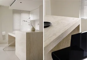 White marble kitchen countertop with a single black dinner plate.