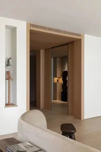 A modern living room featuring wooden furniture, minimalist design, and clean lines.
