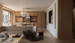 A modern minimalist living room with wooden furniture and fabric accents.